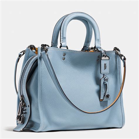 Coach blue satchel - Editor's Notes. Named for the downtown New York neighborhood known for its chic boutiques and stylish residents, Nolita distills the satchel to its essence. The streamlined, feminine design features classic short handles for ladylike handcarrying and a long strap for modern, handsfree wear.